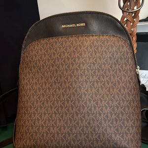 A Michael Kors backpack and wallet set worn maybe three times